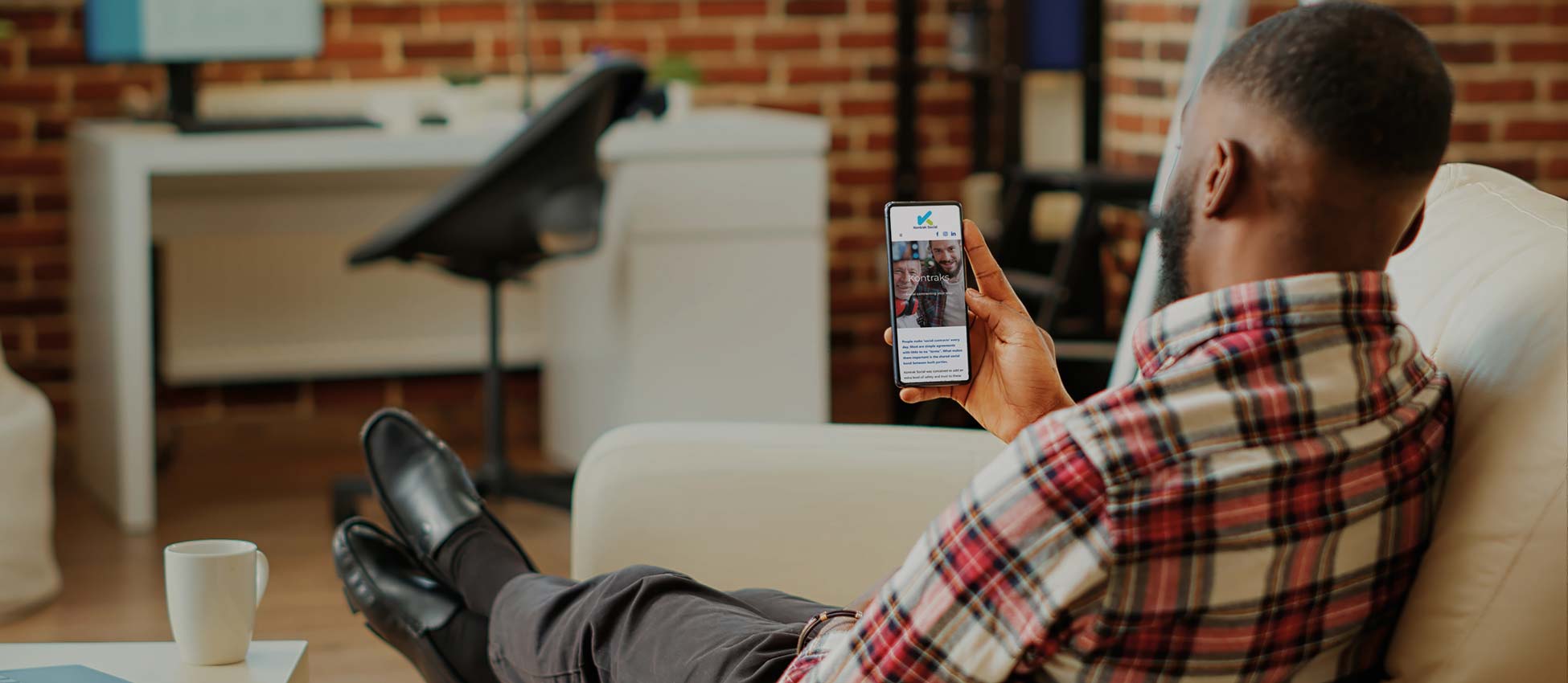 A man browsing the Kontrak Social website on his phone